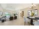 Spacious living room with a dining area, seamless indoor-outdoor flow through sliding glass doors, and a staircase at 6961 Scrub Jay Dr, Sarasota, FL 34241