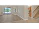 Bright living room showcasing wood floors that lead to an outdoor space and kitchen at 6961 Scrub Jay Dr, Sarasota, FL 34241