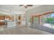 Open-concept living area with wood floors and sliding doors leading to outdoor pool area at 6961 Scrub Jay Dr, Sarasota, FL 34241