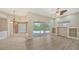 Well-lit living space with tile floors and sliding glass doors to the outdoor pool and patio at 6961 Scrub Jay Dr, Sarasota, FL 34241