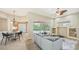 Bright living room with a view of the pool, neutral decor, tile flooring, and a cozy seating area at 6961 Scrub Jay Dr, Sarasota, FL 34241