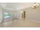 Spacious living room with a dining area, seamless indoor-outdoor flow through sliding glass doors, and a staircase at 6961 Scrub Jay Dr, Sarasota, FL 34241