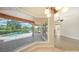 Bright living room with a view of the sparkling pool and outdoor patio overlooking the water at 6961 Scrub Jay Dr, Sarasota, FL 34241