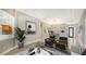 Inviting living room with neutral tones, tray ceiling, elegant decor, and seamless flow into the dining area at 6961 Scrub Jay Dr, Sarasota, FL 34241