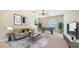 Bright living room featuring a foosball table, neutral decor, and abundant natural light at 6961 Scrub Jay Dr, Sarasota, FL 34241