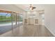 Bright living room with built-in shelving and sliding glass doors to the pool area at 6961 Scrub Jay Dr, Sarasota, FL 34241