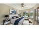 Inviting main bedroom with a large window overlooking the pool and landscaped yard at 6961 Scrub Jay Dr, Sarasota, FL 34241
