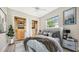 Luxurious main bedroom suite with a plush bed, stylish decor, and custom closet organizers at 6961 Scrub Jay Dr, Sarasota, FL 34241