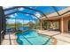 Sparkling pool with a screened enclosure and view of the lake at 6961 Scrub Jay Dr, Sarasota, FL 34241