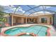 Relaxing pool area with a spa and lush backyard, perfect for outdoor entertaining and leisure at 6961 Scrub Jay Dr, Sarasota, FL 34241