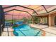 Sparkling pool with a screened enclosure and view of the lake at 6961 Scrub Jay Dr, Sarasota, FL 34241