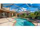 Beautiful in-ground pool and lake view from the screened-in patio at 6961 Scrub Jay Dr, Sarasota, FL 34241