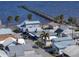 Charming coastal homes with tropical landscaping near a long wooden pier extending into the beautiful blue bay waters at 7 High St, Bradenton, FL 34208