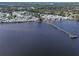 Beautiful overhead view featuring a fishing pier in the bay and homes by a scenic waterfront community at 7 High St, Bradenton, FL 34208