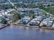 Scenic aerial view of waterfront homes, neighborhood ponds, and a long pier extending into the tranquil bay waters at 7 High St, Bradenton, FL 34208