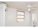 Bedroom featuring a ceiling fan, AC, and paneled walls provides comfort at 7 High St, Bradenton, FL 34208