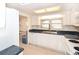 Bright kitchen with white appliances, cabinetry, and a large window at 7 High St, Bradenton, FL 34208