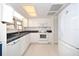 Open kitchen featuring white appliances and plentiful cabinet storage at 7 High St, Bradenton, FL 34208