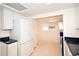 Kitchen with white appliances and cabinetry leads to a small dining area at 7 High St, Bradenton, FL 34208