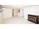 Bright, airy living room with white walls and floors, features a charming electric fireplace at 7 High St, Bradenton, FL 34208
