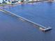 An eye-level aerial view of a fishing pier extending out into the vast, open deep blue bay water at 7 High St, Bradenton, FL 34208
