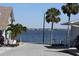 Street view with palm trees leading to waterfront with homes in the background at 7 High St, Bradenton, FL 34208