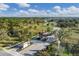 Aerial view of Waverley community entrance, landscaping, and neighborhood of homes among mature trees and winding streets at 7163 Tamworth Pkwy, Sarasota, FL 34241