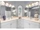 Bathroom with dual sinks, vanity with drawers, mirrors, lighting fixtures, and seahorse decoration at 7163 Tamworth Pkwy, Sarasota, FL 34241