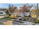 Quaint home featuring a manicured lawn, brick trim, and mature trees at 720 26Th W St, Bradenton, FL 34205