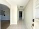 Bright hallway featuring tile flooring and access to various rooms in the house at 7433 N Leewynn Dr, Sarasota, FL 34240