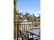 Balcony with a glass table and wrought iron chairs offering relaxing views at 750 N Tamiami Trl # 407, Sarasota, FL 34236