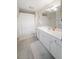 A clean bathroom with a white vanity, large mirror, and a shower with a neutral-colored curtain at 750 N Tamiami Trl # 407, Sarasota, FL 34236