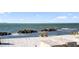 Inviting beach scene with lounge chairs, ocean view, and clear skies at 750 N Tamiami Trl # 407, Sarasota, FL 34236