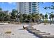 Inviting beachfront with steps to the sand, lounge chairs and a view of the bay at 750 N Tamiami Trl # 407, Sarasota, FL 34236