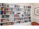 Floor-to-ceiling built-in bookshelves showcase an extensive book collection at 750 N Tamiami Trl # 407, Sarasota, FL 34236