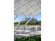 Modern outdoor seating area with tables and chairs under shade at 750 N Tamiami Trl # 407, Sarasota, FL 34236