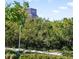 Building exterior viewed through foliage and steps at 750 N Tamiami Trl # 407, Sarasota, FL 34236