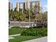Condo exterior with palm trees; lawn and seating area in view at 750 N Tamiami Trl # 407, Sarasota, FL 34236