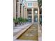 Inviting facade with fountain, columns, and landscaped courtyard at 750 N Tamiami Trl # 407, Sarasota, FL 34236