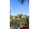 Building exterior with palm trees under a sunny sky; street parking available at 750 N Tamiami Trl # 407, Sarasota, FL 34236