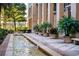 Exterior fountain with water feature, landscaped planters, and building facade at 750 N Tamiami Trl # 407, Sarasota, FL 34236