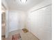 An entryway featuring a tiled floor, closet space, and adjacent access to the bathroom at 750 N Tamiami Trl # 407, Sarasota, FL 34236