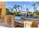 Stainless steel outdoor kitchen grill setup near pond and high-rise building at 750 N Tamiami Trl # 407, Sarasota, FL 34236