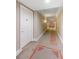 Elegant hallway featuring striped wallpaper, patterned carpet, and decorative details at 750 N Tamiami Trl # 407, Sarasota, FL 34236