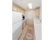 Compact kitchen with wood cabinets, white appliances, and tiled floor, offering functionality at 750 N Tamiami Trl # 407, Sarasota, FL 34236