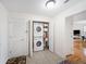 A functional laundry room featuring a stacked washer and dryer unit for space-saving convenience at 750 N Tamiami Trl # 407, Sarasota, FL 34236