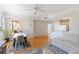 Open layout with hardwood floors, a dining area, living room with a sofa and a glimpse of the kitchen at 750 N Tamiami Trl # 407, Sarasota, FL 34236