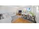 Open floor plan with hardwood floors, comfortable sofa, dining area and lots of natural light at 750 N Tamiami Trl # 407, Sarasota, FL 34236