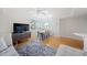 Bright living room featuring hardwood floors, a ceiling fan, and a dining area with natural light at 750 N Tamiami Trl # 407, Sarasota, FL 34236