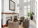 Elegant lobby features high ceilings, a fireplace, decorative mirror, chairs, and a plant at 750 N Tamiami Trl # 407, Sarasota, FL 34236